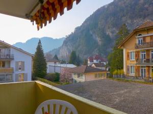 a balcony with a view of a town with mountains at Apartment Harder by Interhome in Interlaken