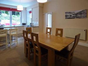 a kitchen and dining room with a wooden table and chairs at White Moss, Wood Close in Grasmere