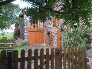 a wooden fence in front of a house at Holiday Home ferme by Interhome in Agizoux