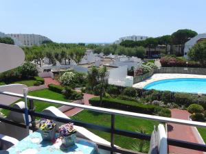 a balcony with a view of a swimming pool at Apartment Du Soleil-2 by Interhome in La Grande Motte