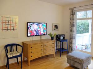 a living room with a tv on top of a dresser at Apartment Juliusruh-3 by Interhome in Juliusruh