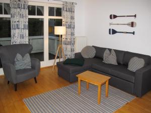a living room with a couch and two chairs and a table at Apartment Juliusruh-3 by Interhome in Juliusruh +11 photos