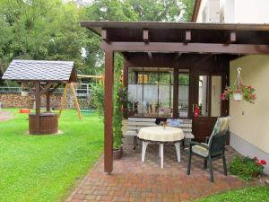 a patio with a table and a gazebo at Apartment Am Burgberg by Interhome in Eilenburg