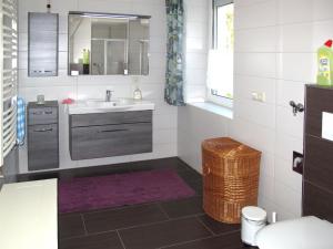 a bathroom with a sink and a mirror at Apartment Am Burgberg by Interhome in Eilenburg