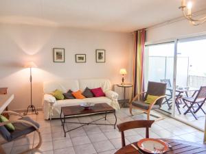 a living room with a white couch and chairs at Apartment Les Flots Cypriano by Interhome in Saint-Cyprien-Plage