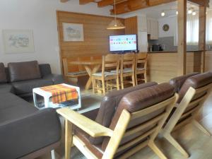 a living room with a couch and a table at Apartment Chalet Casa Almis 5 by Interhome in Grindelwald