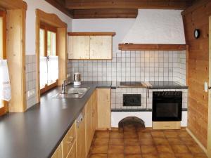a kitchen with a sink and a stove top oven at Holiday Home Marianne by Interhome in Reit im Winkl