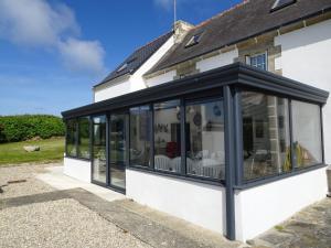 a conservatory on the side of a house at Holiday Home Kerludu by Interhome in Kerloch