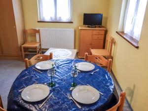 a dining room table with a blue and white table cloth at Apartment apt 2 by Interhome in Marckolsheim