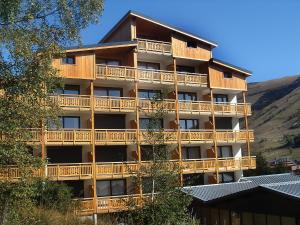 a large building with balconies on the side of it at Apartment Le Super Venosc by Interhome in Les Deux Alpes