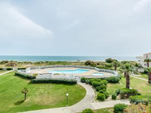 an aerial view of a resort with a swimming pool and the ocean at Apartment Les Goelettes-8 by Interhome in Saint-Cyprien-Plage