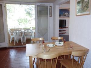 a dining room with a wooden table and chairs at Apartment Super Ile Rousse by Interhome in Bandol