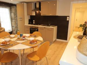 a kitchen and dining room with a table and chairs at Holiday Home Ty Coz - PZV 106 by Interhome in Plozévet