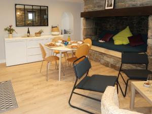 a living room with a table and chairs and a bed at Holiday Home Ty Coz - PZV 106 by Interhome in Plozévet +20 photos