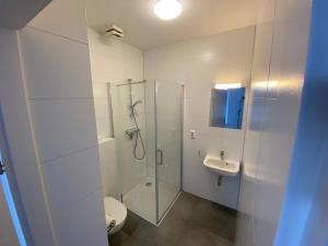 a bathroom with a shower and a toilet and a sink at Short Stay Wageningen in Wageningen