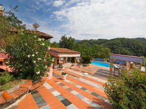 a house with a swimming pool and a patio at Villa La Chiazza by Interhome in Corsanico-Bargecchia