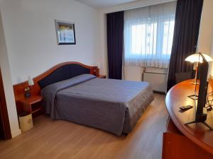 Krevet ili kreveti u jedinici u objektu Hotel Donizetti