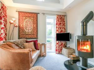 a living room with a couch and a fireplace at South Lodge in Sturminster Newton