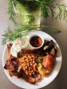 a plate of food with eggs beans and other foods at Church Farm Guest House in Wellington