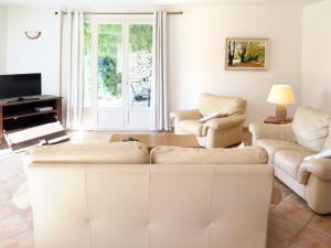 カジャルクにあるHoliday Home La Combelle - CJC400 by Interhomeのリビングルーム(ソファ、椅子、テレビ付)