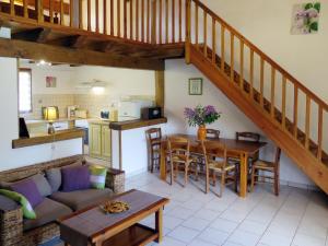 a living room with a couch and a table at Holiday Home Au Cayroux - BSB302 by Interhome in Blanquefort-sur-Briolance