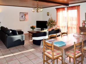 een woonkamer met een tafel en een bank bij Holiday Home Le Coustal - BSB300 by Interhome in Blanquefort-sur-Briolance