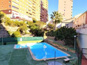 an empty swimming pool in an apartment with buildings at Apartment Don Miguel III by Interhome in Cala de Finestrat