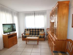 sala de estar con sofá y TV en Apartment Tamarindo by Interhome, en Cala de Finestrat