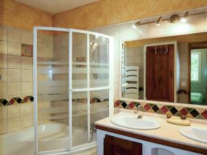 a bathroom with a tub and a sink and a shower at Holiday Home Sweet Home in Luberon - VLU100 by Interhome in Villelaure
