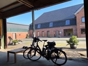 a bike parked next to a bench in a building at Gästezimmer & Appartement Elskop in Elskop