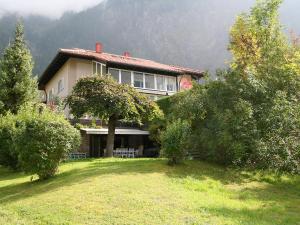 a house on a hill with trees in front of it at Apartment Casa Hubertus by Interhome in Oetz
