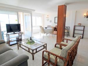 a living room with a couch and a tv at Apartment Turia Playa by Interhome in Benidorm