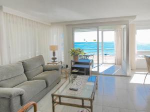 a living room with a couch and a view of the ocean at Apartment Turia Playa by Interhome in Benidorm +15 photos