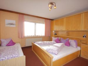 a bedroom with two beds and a window at Apartment Karwendel by Interhome in Oberau