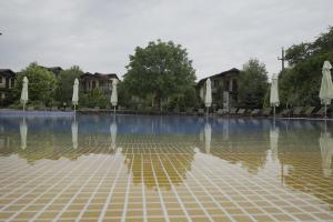 a pool of water with white umbrellas in it at CLUB D'OR in Vama Veche