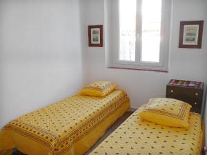 two twin beds in a room with a window at Apartment Les Lecques by Interhome in Saint-Cyr-sur-Mer