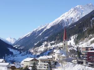 a town in the snow with mountains in the background at Apartment La Luna by Interhome in Kappl