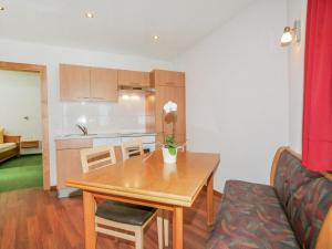 a living room with a table and a kitchen at Apartment La Luna by Interhome in Kappl