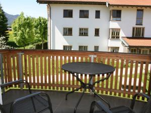 a table and chairs on a balcony with a building at Apartment Bibelöd-2 by Interhome in Ruhpolding