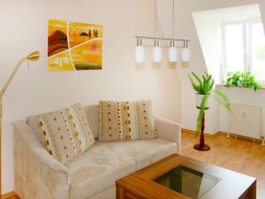 a living room with a couch and a coffee table at Apartment Kamelienweg by Interhome in Dresden