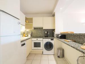 a kitchen with a washer and dryer in it at Apartment Le Magellan-2 by Interhome in Saint-Raphaël
