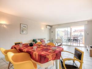 a dining room with a table and chairs and a room at Apartment Le Magellan-2 by Interhome in Saint-Raphaël