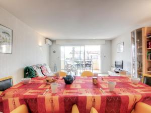 a living room with a table and a couch at Apartment Le Magellan-2 by Interhome in Saint-Raphaël