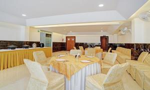 a dining room with a table and chairs at Treebo Trend Shivaay in Indore