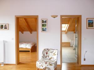a bedroom with a bed and a chair in a room at Apartment Bibelöd-5 by Interhome in Ruhpolding