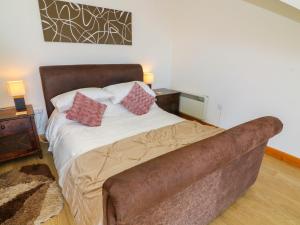 a bed with a couch in a room at Shorefields One in Morecambe