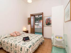 a bedroom with a bed with a laptop on it at Apartment A'Scalinatella by Interhome in Positano