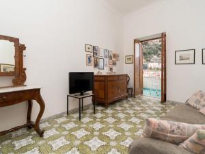 a living room with a couch and a television at Apartment A'Scalinatella by Interhome in Positano