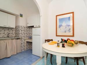 a kitchen with a table with a bowl of fruit on it at Apartment A'Scalinatella by Interhome in Positano +12 photos