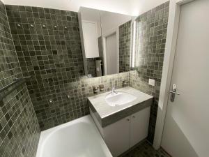 a bathroom with a sink and a mirror at Apartment Chesa Alvetern 5 by Interhome in Sils Maria